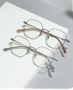 Detail of rose gold and silver titanium polygon frames with blue light blocking lenses