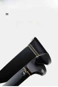 Detail of premium black sunglasses showing gold metal hinge and high-elastic frame texture