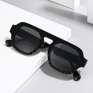 Retro pilot oversized sunglasses with black vertical textured frames and dark lenses