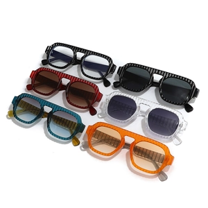 Vintage pilot sunglasses with striped thick frames in six assorted colors on white backdrop