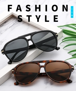 Detail of aviator sunglasses with double-bridge frame and stylish metal accents