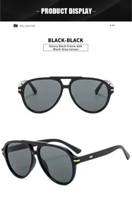 Detail of pilot sunglasses with glossy black frames and gold metal temple accents