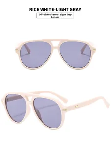 Detail of rice white pilot sunglasses with light gray lenses and golden metal hinges