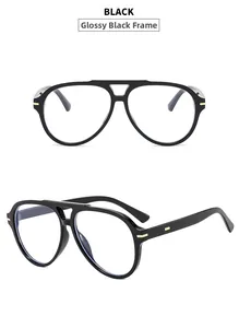 Detail view of glossy black double-bridge pilot sunglasses frames with gold metal accents