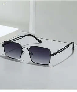 Detail of square sunglasses with spiral texture metal temples on a white geometric block