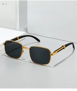 Detail of square gold metal sunglasses with wood texture temples and three-ring hinges