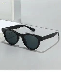 Detailed macro view of black oversized sunglasses frame with silver metal stud accents