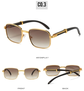 Detail of vintage rectangular gold metal sunglasses with dark wood grain textured temples