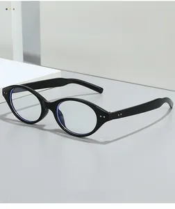 Detail showing oval blue light blocking glasses with vintage metal rivets on black frame