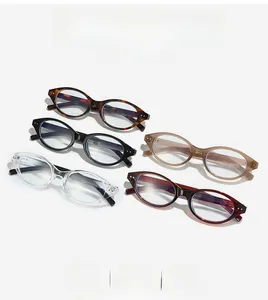 Flat lay of oval blue light blocking glasses in black, transparent, and tortoiseshell