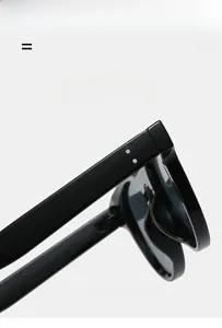 Detail view of glossy black sunglass hinges and silver round rivet decorations