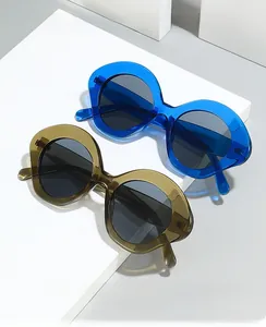 Detailed view of oversized oval sunglasses in transparent blue and tea brown shades