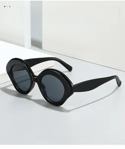 Detail of trendy black oval sunglasses with thick frames and premium textured material