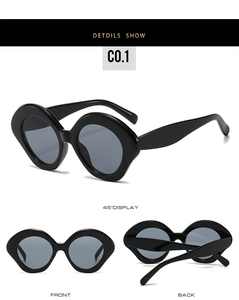 Detailed views of chunky black oval sunglasses with bold geometric frame and dark lenses