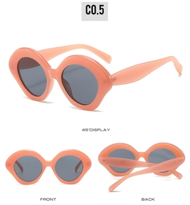 Three perspectives of peach pink oval sunglasses with gray lenses and thick frames