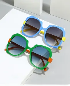 Detail of colorful children butterfly sunglasses with blue and green frames on white blocks