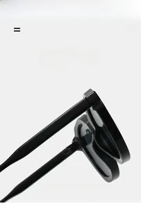 Detailed macro view of the slim hinges and high-gloss black oval sunglasses frames