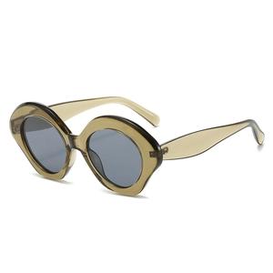 Fashionable oversized oval sunglasses with light brown translucent frames and dark grey lenses