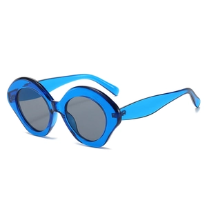 Modern oval sunglasses with transparent blue resin frame and dark gray lenses