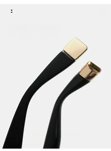 Detail of curved black sunglasses legs with premium gold metal ends for comfort