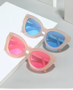 Detail of pink and blue oversized cat eye sunglasses with matte translucent frames