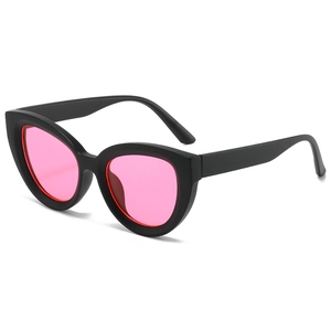 Chic cat-eye sunglasses with black matte frames and vibrant translucent pink lenses