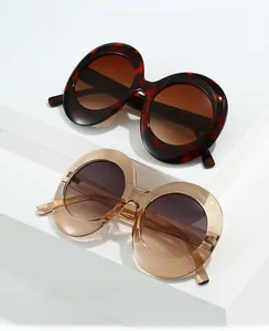 Detail of oversized oval sunglasses in tortoise shell and champagne frame colors