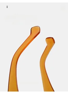 Detail of curved oval sunglasses legs in amber resin for comfortable wear
