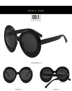 Three-view perspective of oversized oval black sunglasses in polished plastic finish