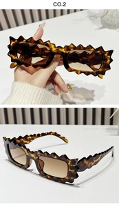 Close-up of wavy tortoise shell frame sunglasses with brown gradient lenses