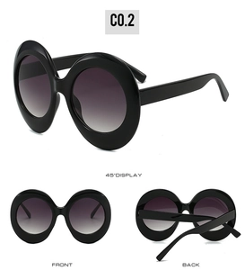 Multi-angle view of oversized oval sunglasses with black frames and gradient lenses