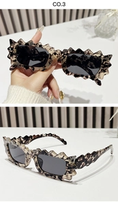 Close-up of stylish tortoise shell sunglasses with unique irregular wavy scalloped frames