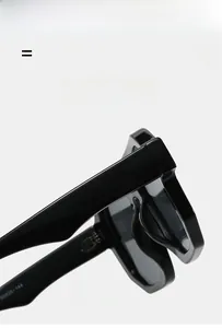 Detail of glossy black oversized sunglasses frame with metal hinges and size engraving