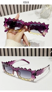 Macro detail of irregular wavy frame sunglasses featuring purple to yellow gradient lenses