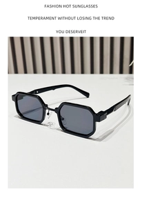 Detail of black hexagonal sunglasses with silver rivets and metal nose pads
