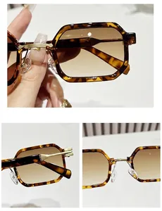 Detail view of tortoiseshell sunglasses with brown gradient lenses and gold metal hinges