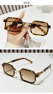 Detailed side view of tortoise shell sunglasses with gold metal hinges and brown lenses
