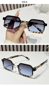 Detail of geometric rectangle sunglasses with blue gradient lenses and gold bridge