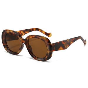 Retro oversized oval tortoiseshell sunglasses with brown lenses on a white background