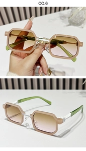 Detail of square sunglasses with pink frame, gradient lenses and green temples