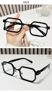 Detail view of vintage square sunglasses with thick black frames and geometric design