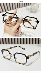 Detail of vintage square sunglasses with black and tortoise shell frames and gold metal hinge