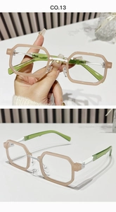Close-up of geometric pink frames and green temples on stylish square sunglasses
