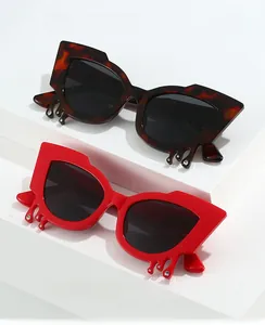 Detail of cat eye sunglasses featuring unique fluid droplet frames with sparkling rhinestones