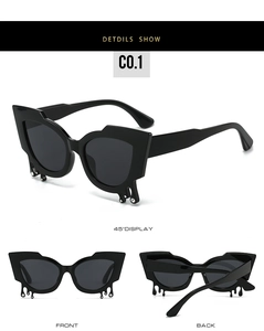 Detail view of black cat-eye sunglasses with rhinestone teardrop design and C0.1 frame style