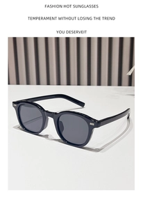 Detailed view of oval leopard sunglasses with silver hinge and dark grey lenses