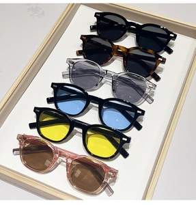 Detailed view of oval leopard print and black vintage sunglasses with metal rivets