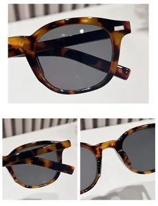 Macro details of leopard print sunglasses featuring metal rivets and polished tortoiseshell texture