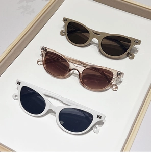 Detailed macro view of trendy cat-eye sunglasses with printed frame size specifications