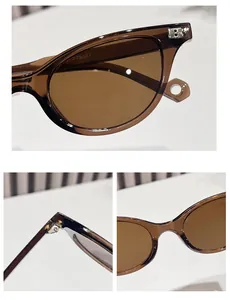 Detail view of tea brown sunglasses showing the B-shape metal logo and hinge hardware